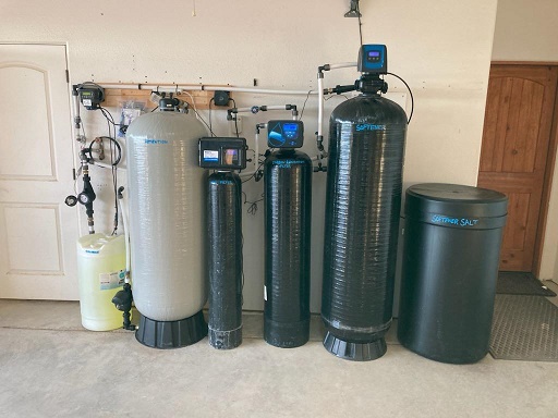 Well water treatment and softener system installed in a home garage
